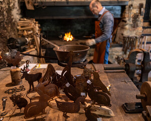 Blacksmith Crafting Metal Art in Traditional Workshop