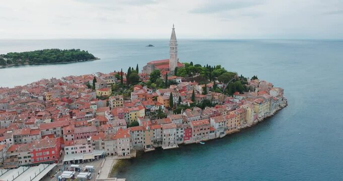 The city of Rovinj on Croatia&rsquo;s Adriatic coast is dazzling with its narrow stone streets, colorful historic houses, and the soaring spire of St. Euphemia&rsquo;s Church. A drone hovers over the city and cir