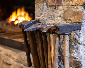 Traditional Blacksmith Hammers Near Forge Fire