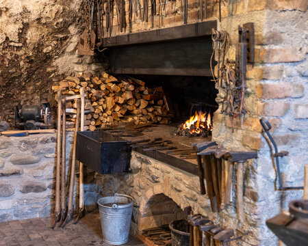 Traditional Blacksmith Forge with Tools and Firewood
