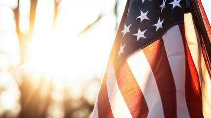 Sunlight illuminates a waving American flag against a bright sky, ideal for patriotic or memorial themed designs