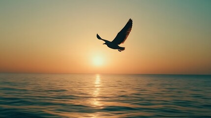Fototapeta premium A silhouette of birds flying over the ocean at dawn