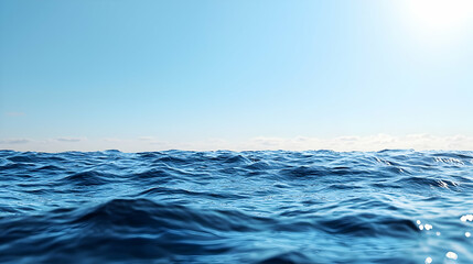 Obraz premium Blue Ocean Surface Under Clear Sky with Sunlight and Calm Water During Daytime