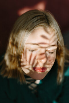 Teenager in natural light with shadow play on face