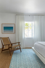Fototapeta premium Bright and airy bedroom with coastal decor and natural light in a modern home