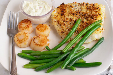 baked haddock served with scallops and green beans