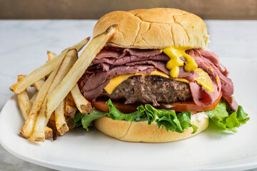 roast beef  cheese burger with a side of fries