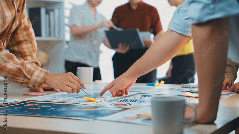 Poster a dynamic scene of teamwork in a modern office, featuring hands engaged in collaborative strategy de
