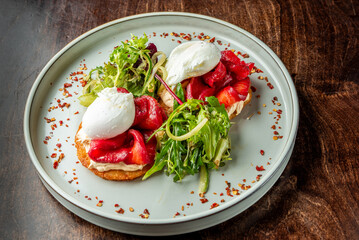 A delightful plate featuring two poached eggs atop a crispy base, garnished with vibrant red beets...