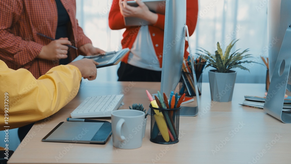 Poster a vibrant office scene showcasing a collaborative workspace with team members discussing strategies 