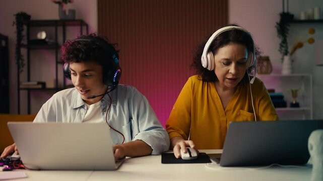 Teen son and his mom celebrating a video game victory by giving a high five