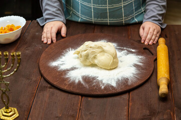 Cookie dough on a table sprinkled with flour next to