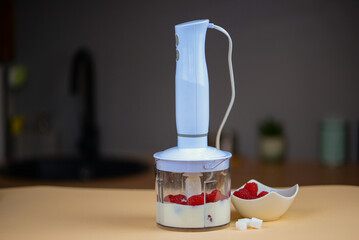 Blender with yogurt and berries, concept of diet and healthy food