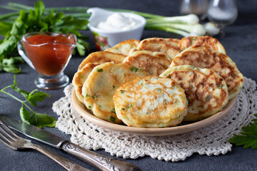 Fried fritters with green onion and cheese served for breakfast with ketchup