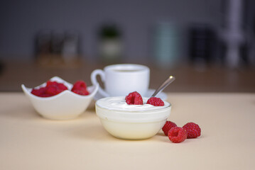 Dessert with raspberries on the table in the kitchen