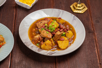 Chelnt with potatoes, beans and meat, traditional food on Shabbat. Horizontal photo.
