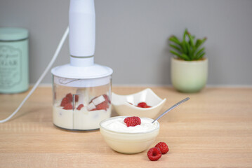 Blender with yogurt and berries, concept of diet and healthy food