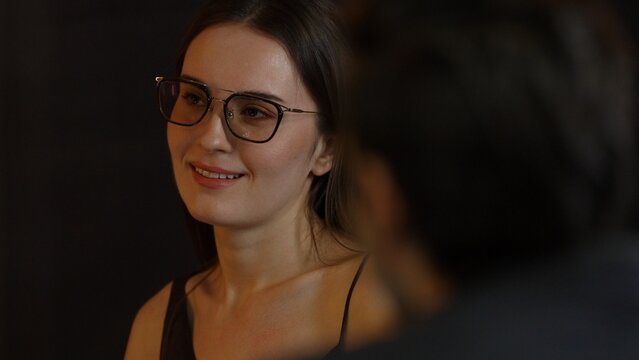 Portrait of drinking cocktail beautiful woman engaging conversation with friend or couple at back side at luxurious counter. Capturing essence social upscale interaction scene at night life. Vinosity.