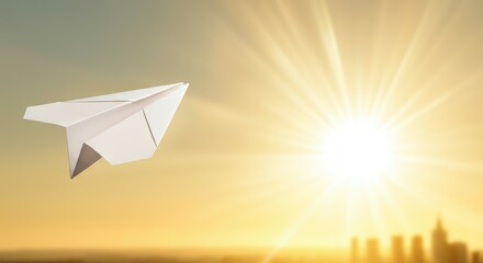 Origami paper airplane flying towards bright sunset