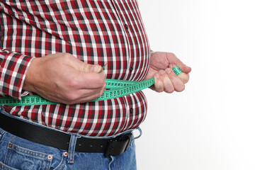 Overweight man measuring his belly with tape on white background, closeup. Space for text