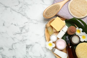 Flat lay composition with different body care products on white marble table. Space for text