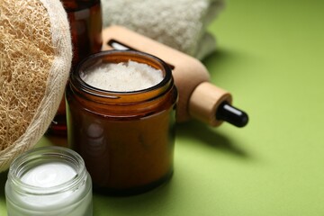 Different body care products on green background, closeup. Space for text
