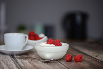 Greek yogurt with raspberries and coffee, healthy breakfast