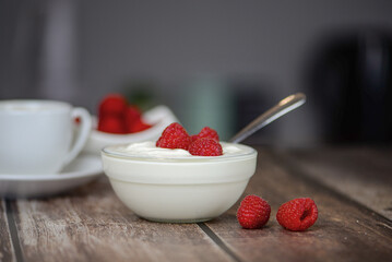 Greek yogurt with raspberries and coffee, healthy breakfast