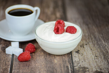 Greek yogurt with raspberries and coffee, healthy breakfast