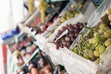 Bunches of grapes in boxes in a store. Organic fruits