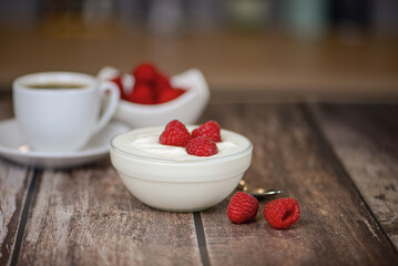 Greek yogurt with raspberries and coffee, healthy breakfast
