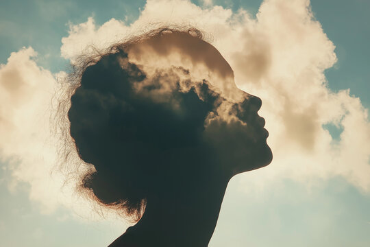 A conceptual image of brain circuitry within a human head silhouette against a cloudy sky, symbolizing intelligence, consciousness, neuroscience, and futuristic mind concepts.