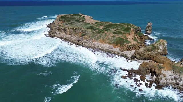 Drone view over rocky cliff of Ilheu da Papoa Hiking area in Peniche, Portugal on a summer day