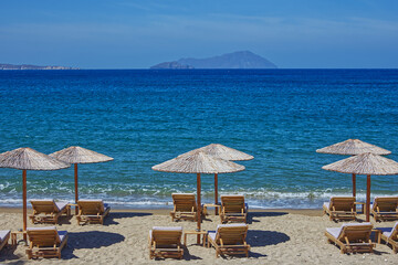 Part view of a resort beach with deck chairs and parasols