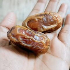 Close-up of Fresh Dates in Hand