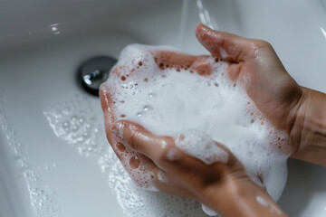 Fototapeta premium Hands lathered with soap for cleanliness routine.