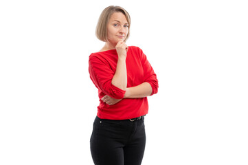 A thoughtful woman in a red sweater with a hand on her chin against a white background.