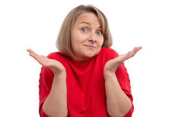 Fototapeta premium A woman with short hair in a red sweater shrugging her shoulders with a playful expression.