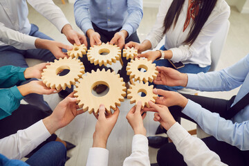 Diverse people hands assembling gear puzzle mechanism for common progress, teamwork, connection,...