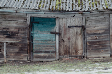 Close-Up of Weathered Wooden Barn Doors with Rusty Locks. Aged Farm Barn with a Blue Wooden Door...
