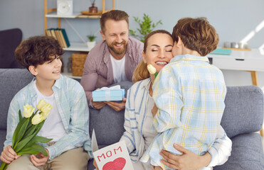 Father and two kids congratulate happy mother and wife with International Women Day, Mother Day or...