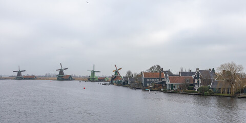 View of typical windmills in the Dutch town of Zaanse Schans on a winter morning