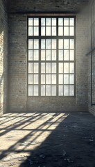 Interior view featuring a large window and brick walls casting shadows