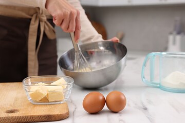 Woman making dough at white marble table indoors, closeup
