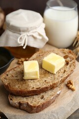 Slices of bread with butter, honey and milk on table, closeup
