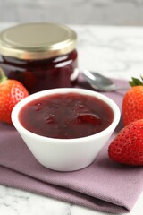 Delicious strawberry sauce and fresh berries on white marble table, closeup