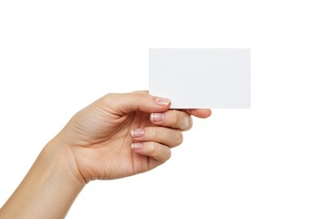 A hand with neatly manicured nails holding a blank white business card isolated on white background