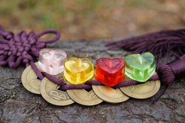 Chinese feng shui coins and glass colored hearts.
