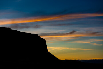Silhouettes of sandstone buttes in the desert of Monument Valley, in Arizona and Utah.