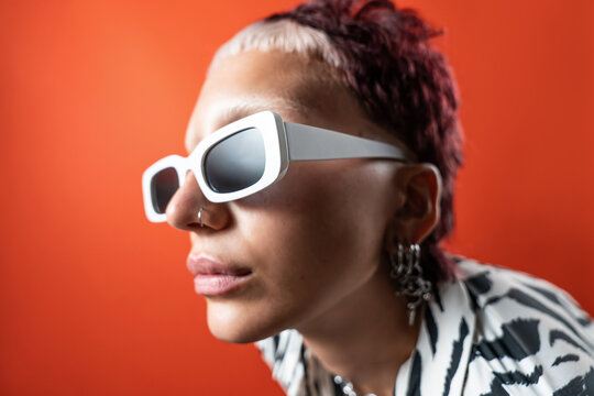 Fashion model with animal print outfit and bold white sunglasses